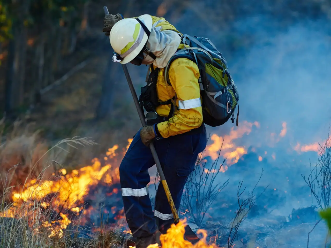Firefighter in full gear working a fire line